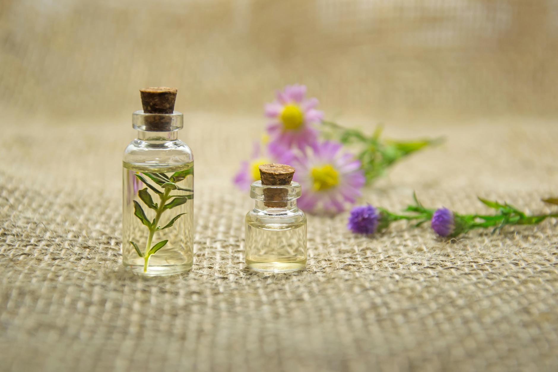 two clear glass bottles with liquids